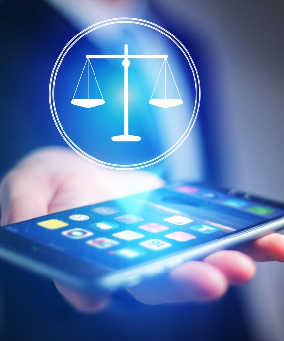 View of a Businessman hand holding mobile phone with justice icon